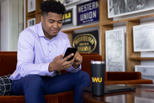 Western Union employee sitting on phone